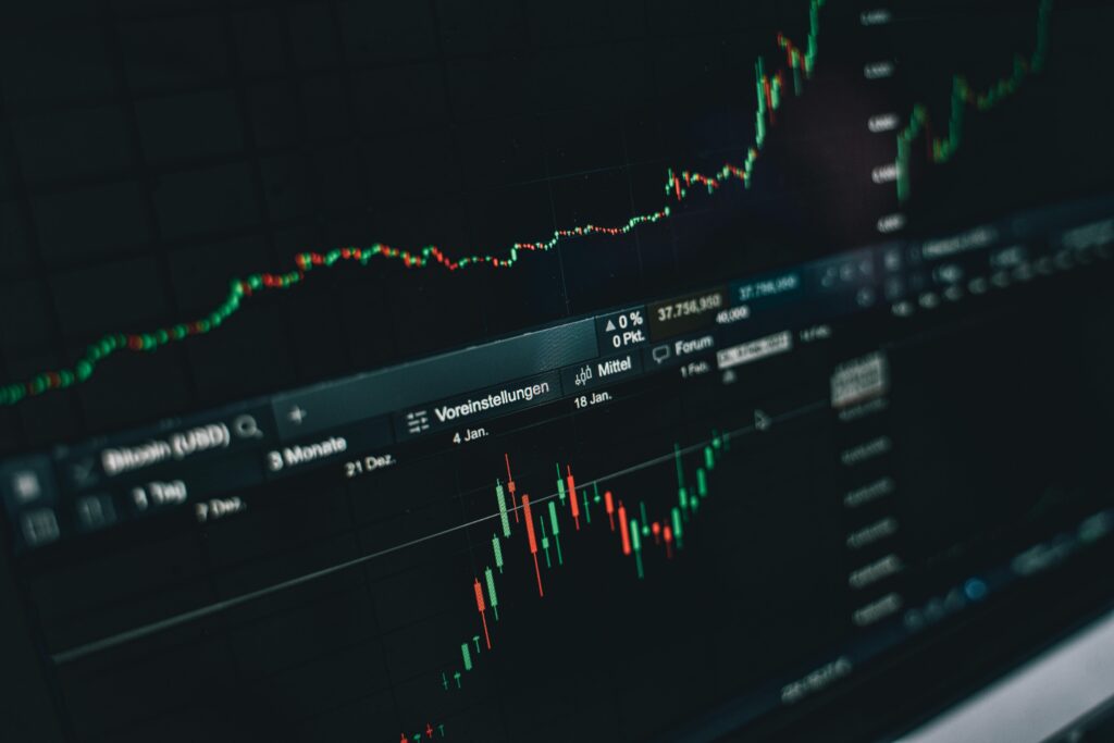 Close-up of a digital market analysis display showing Bitcoin and cryptocurrency price trends.